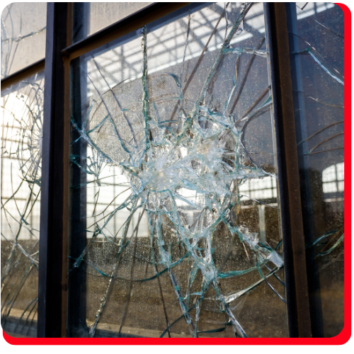 Close-up of shattered commercial glass window from high wind impact in Toronto industrial facility
