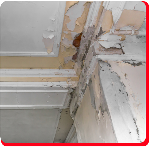 A deteriorating ceiling and wall corner in a commercial building showing severe water damage, peeling paint, and crumbling plaster, representative of large loss restoration needs in Toronto, Ontario.